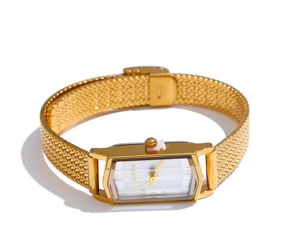 A gold stainless steel banded women's watch with a square dial and a digital display, featuring a gold case and a deployment buckle.